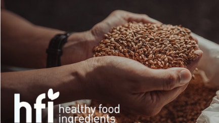 person holding handful of seeds hfi logo